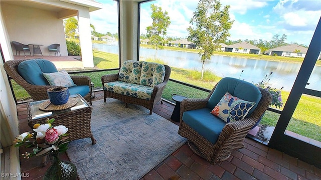 sunroom / solarium featuring a water view