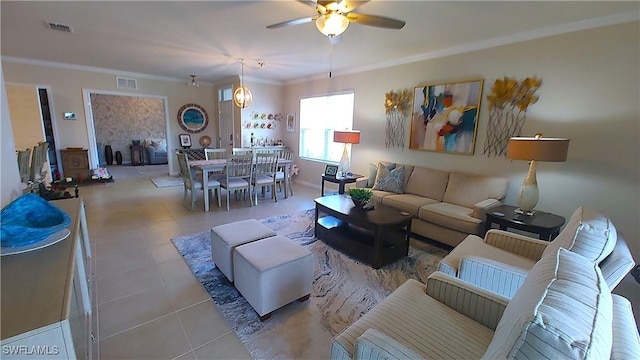 living room featuring light tile patterned floors, ornamental molding, and ceiling fan