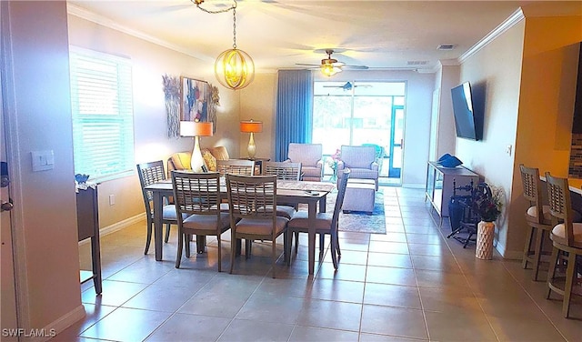 dining area with crown molding, tile patterned floors, and ceiling fan