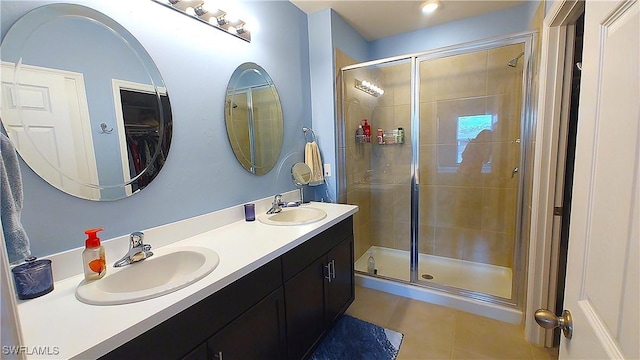 bathroom featuring an enclosed shower, vanity, and tile patterned flooring