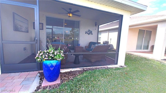 view of patio featuring ceiling fan and a sunroom