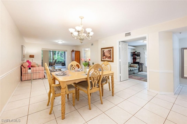 dining space featuring an inviting chandelier and light tile patterned floors