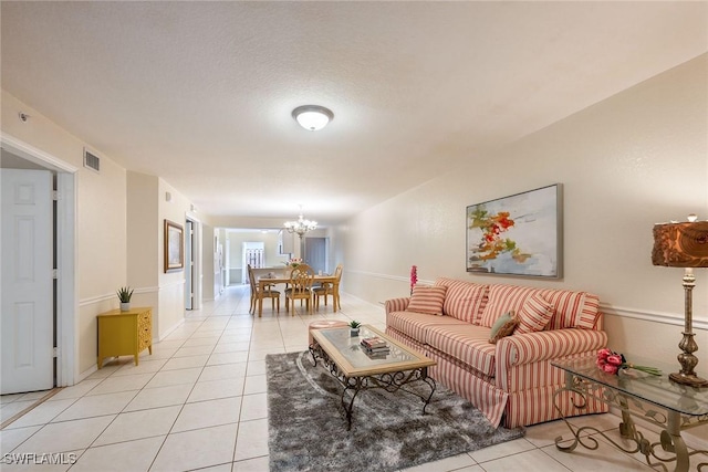 living room featuring an inviting chandelier and light tile patterned floors