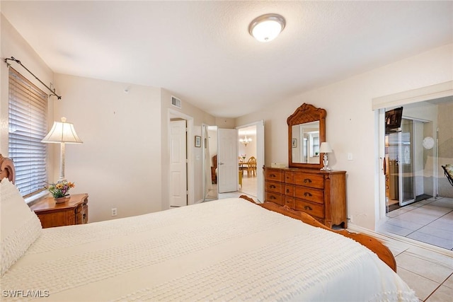 bedroom featuring access to outside and light tile patterned floors