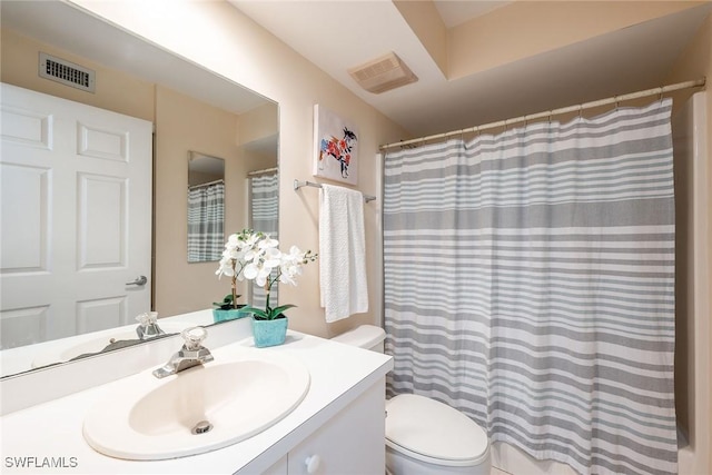 bathroom with vanity, toilet, and a shower with shower curtain