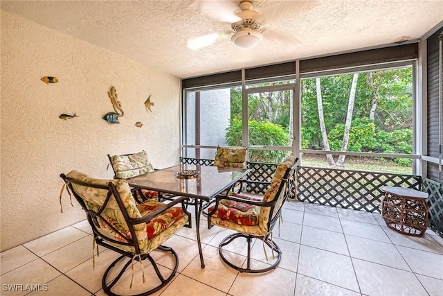 sunroom featuring ceiling fan and a wealth of natural light