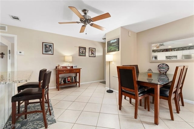 tiled dining room with ceiling fan