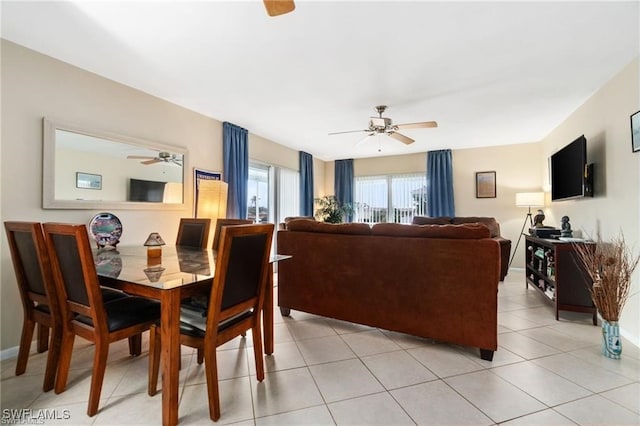 tiled dining space featuring ceiling fan