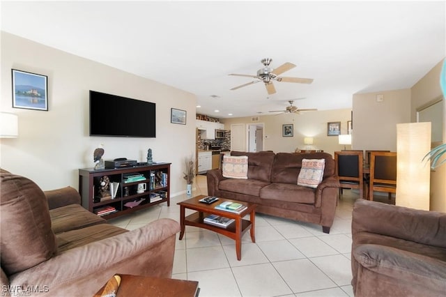 living room featuring light tile patterned flooring and ceiling fan