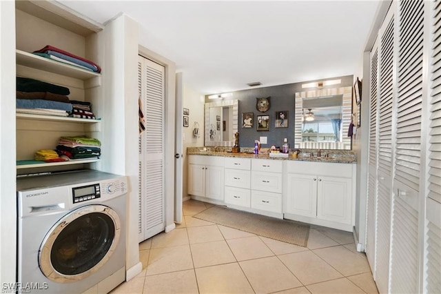 laundry room featuring washer / clothes dryer, light tile patterned floors, and sink