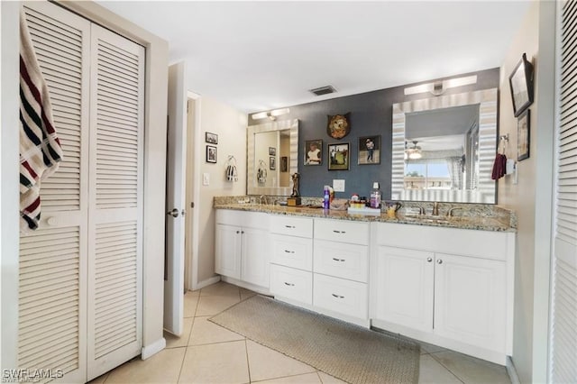 bathroom featuring tile patterned flooring and vanity