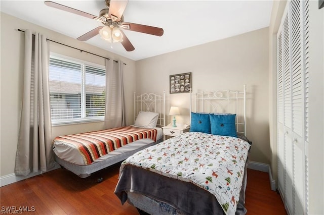 bedroom with hardwood / wood-style flooring, ceiling fan, and a closet