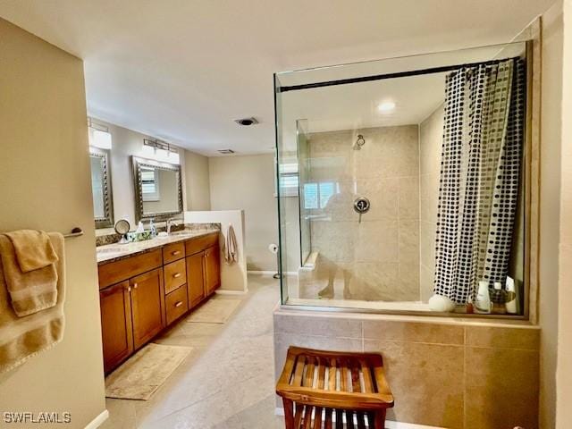 bathroom with tile patterned floors, vanity, and a shower with door