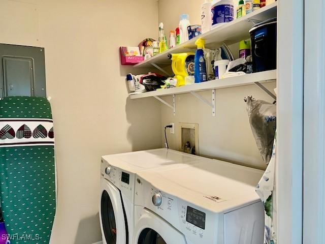 clothes washing area featuring washer and clothes dryer