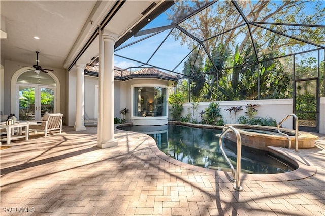 view of pool with french doors, glass enclosure, ceiling fan, a hot tub, and a patio area