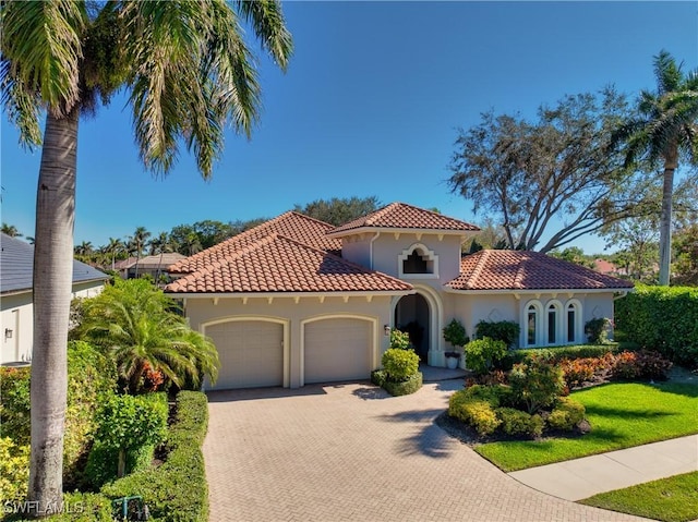 mediterranean / spanish house with a garage