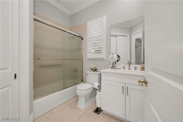 full bathroom featuring toilet, combined bath / shower with glass door, crown molding, vanity, and tile patterned flooring