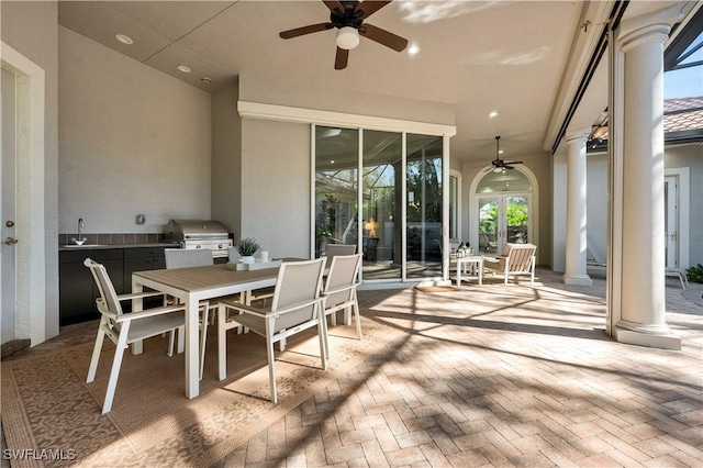 view of patio / terrace featuring exterior kitchen, a grill, sink, and ceiling fan