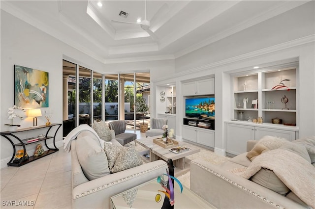 tiled living room with a tray ceiling, built in features, ornamental molding, and a high ceiling