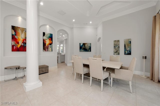 tiled dining area with ornamental molding and ornate columns