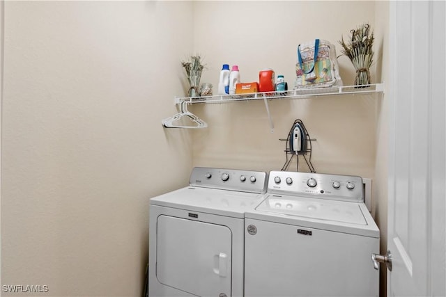 clothes washing area with washer and dryer