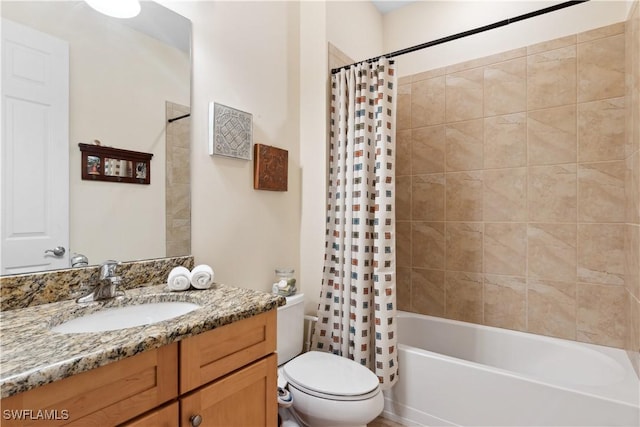 full bathroom with shower / tub combo with curtain, vanity, and toilet