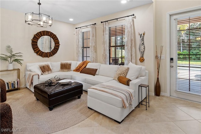 living room with an inviting chandelier and light tile patterned floors