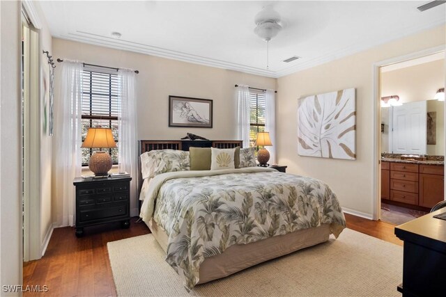 bedroom with ceiling fan, ensuite bathroom, dark hardwood / wood-style floors, and multiple windows