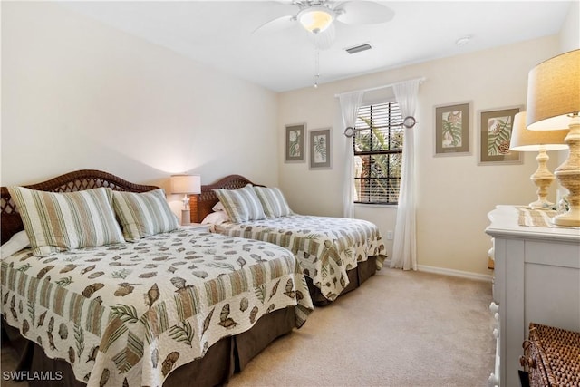 bedroom featuring light colored carpet and ceiling fan