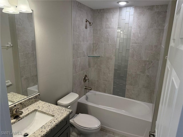 full bathroom featuring vanity, toilet, and tiled shower / bath