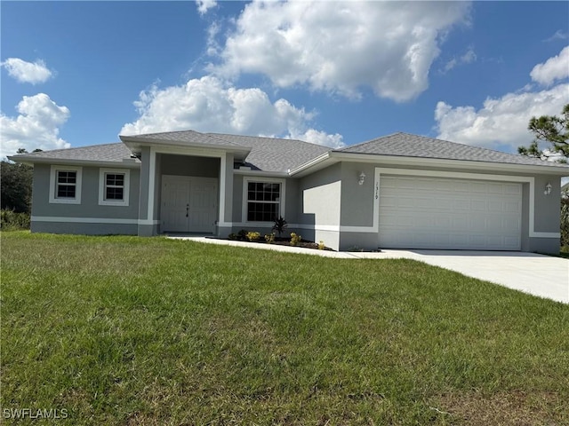 view of front of house with a garage and a front lawn