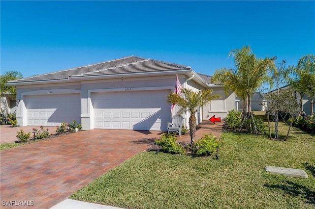 view of front of home with a garage and a front yard