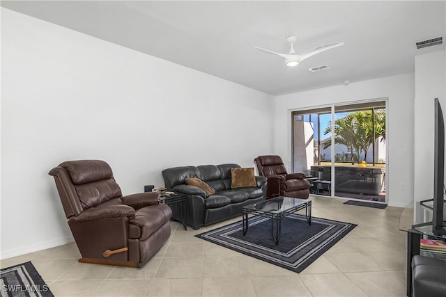 tiled living room with ceiling fan