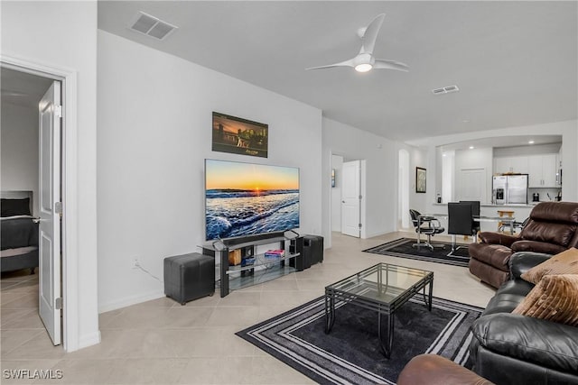 living room featuring ceiling fan and light tile patterned floors