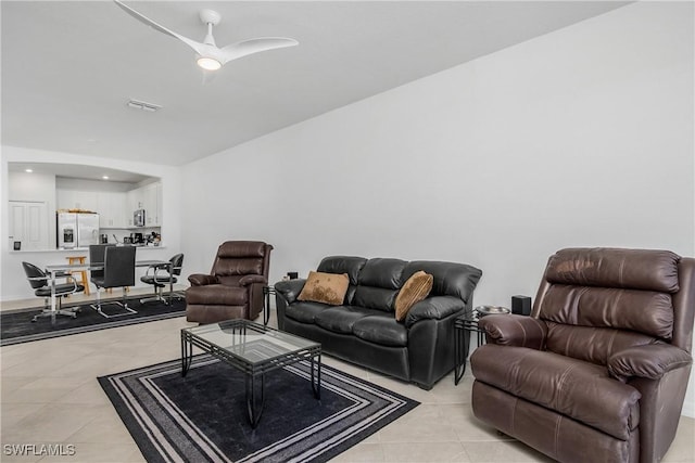 living room featuring light tile patterned flooring and ceiling fan