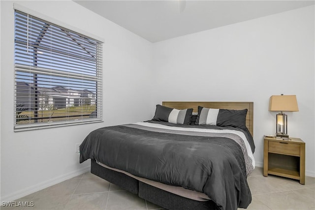 bedroom with light tile patterned floors