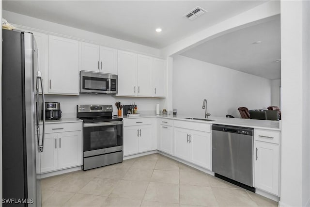 kitchen featuring white cabinetry, appliances with stainless steel finishes, and sink