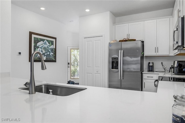 kitchen featuring white cabinetry, sink, and stainless steel appliances