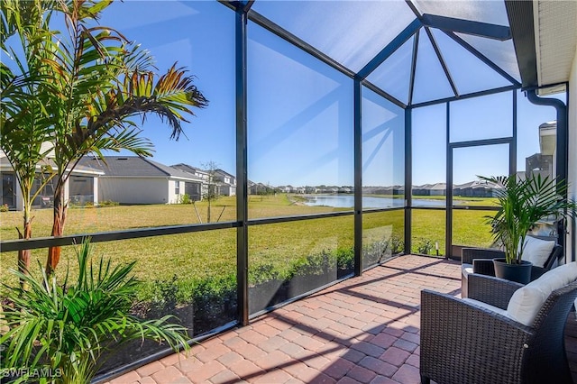 sunroom / solarium featuring a water view and plenty of natural light