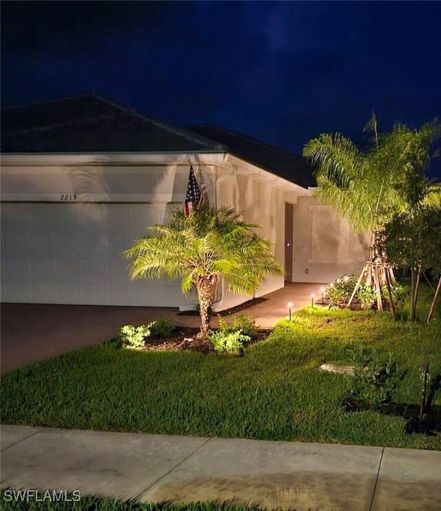 property exterior at twilight featuring a yard