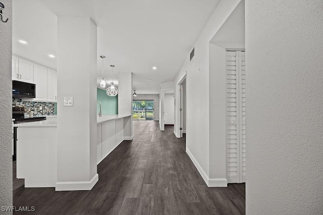 corridor with dark hardwood / wood-style floors