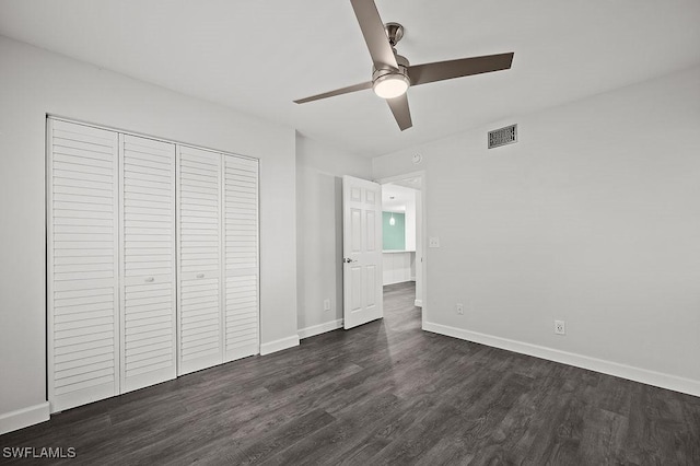 unfurnished bedroom featuring ceiling fan, dark hardwood / wood-style floors, and a closet