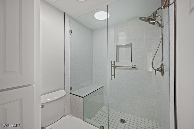 bathroom with toilet and walk in shower