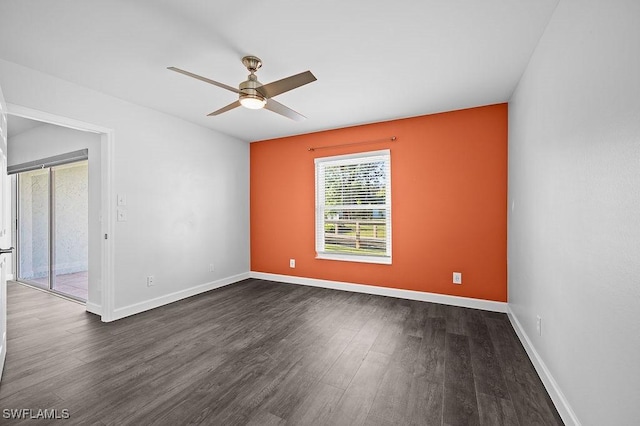 empty room with dark hardwood / wood-style floors and ceiling fan