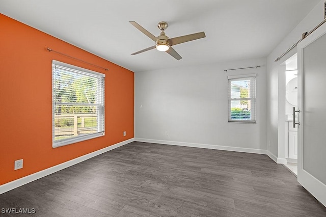 spare room with ceiling fan and dark hardwood / wood-style floors