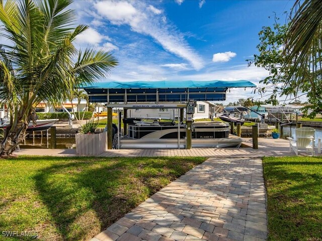 dock area featuring a water view and a yard