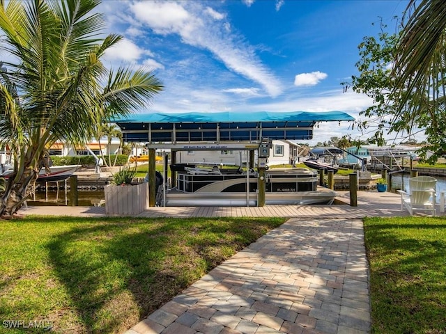 dock area featuring boat lift and a yard