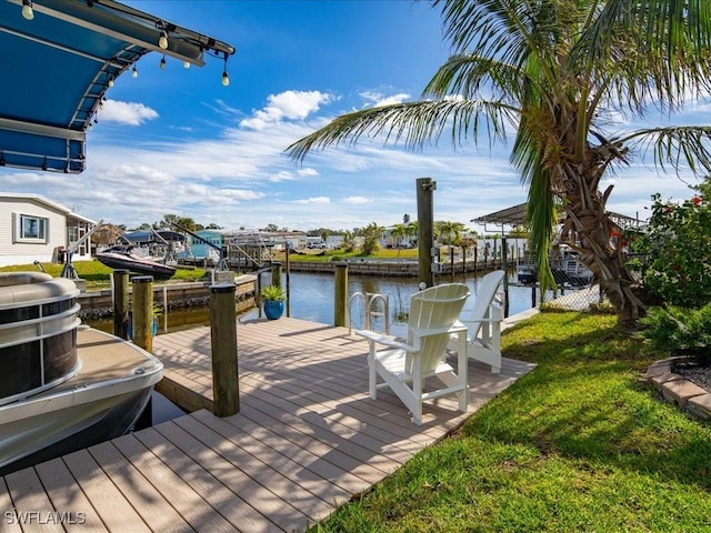 dock area with a yard and a water view