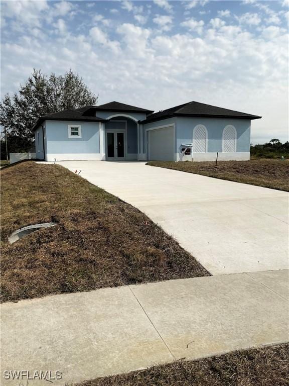 view of front of home featuring a garage and french doors