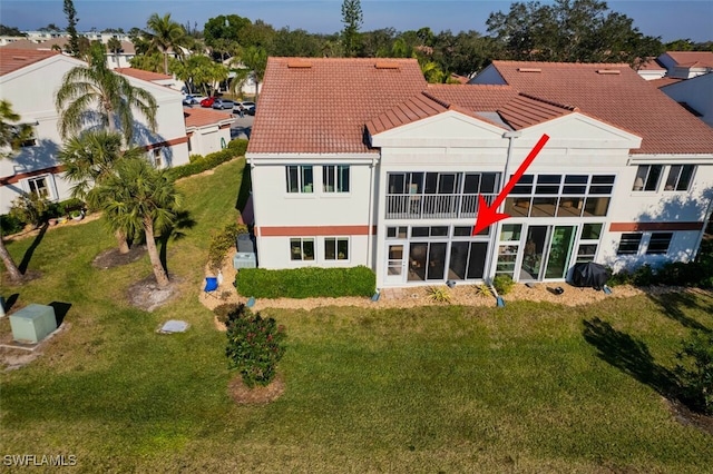 rear view of house with a lawn